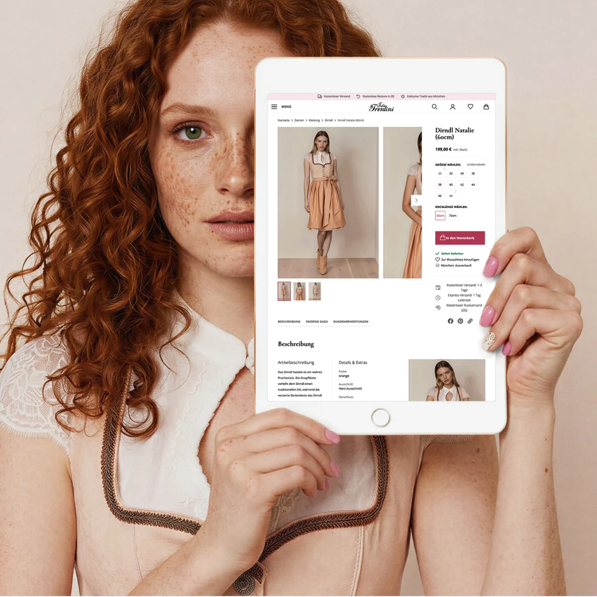 Julia Trentini e-commerce preview on a tablet showcasing premium alpine fashion, held by a model in a matching traditional dirndl