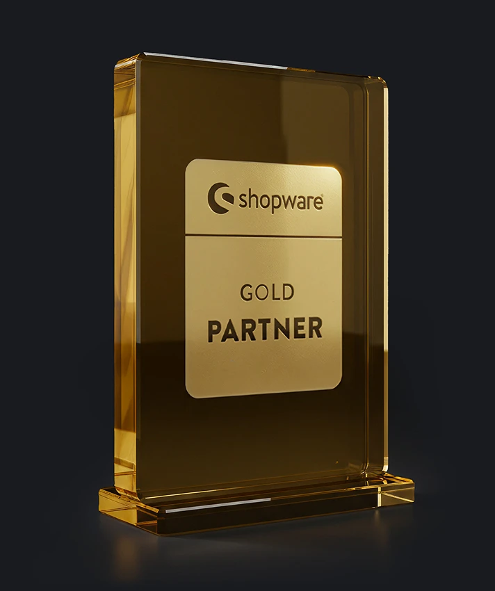 Shopware Gold Partner award trophy as a golden glass block on a dark background