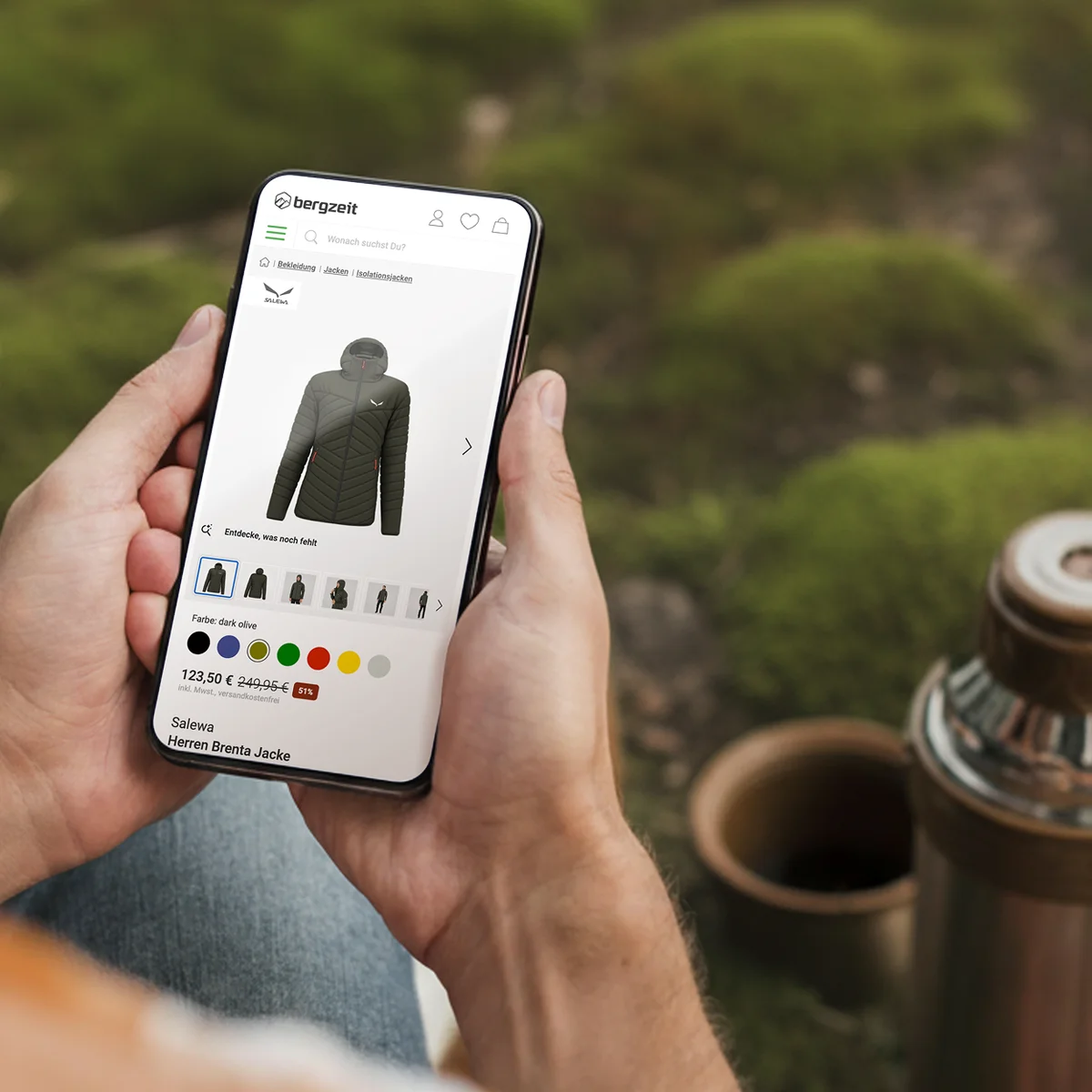 Bergzeit e-commerce website preview on a smartphone showcasing the "Salewa Herren Brenta Jacke" product page alongside outdoor gear in a natural setting