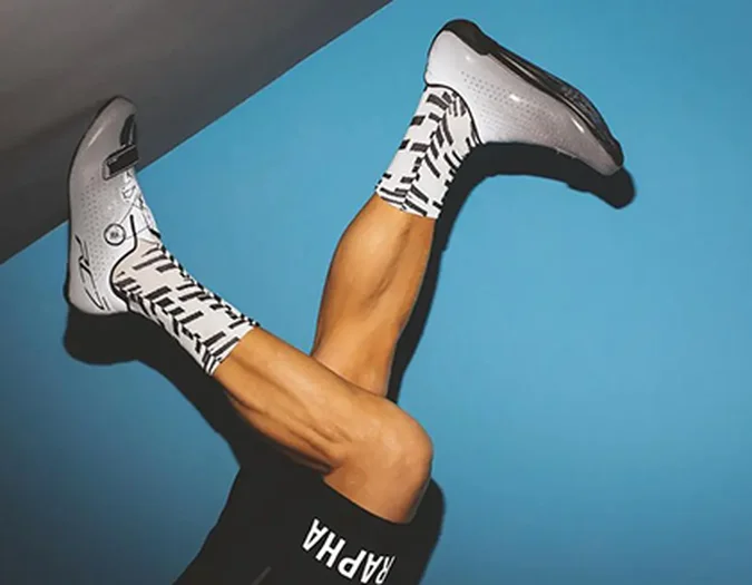 Legs in motion wearing sneakers on blue background