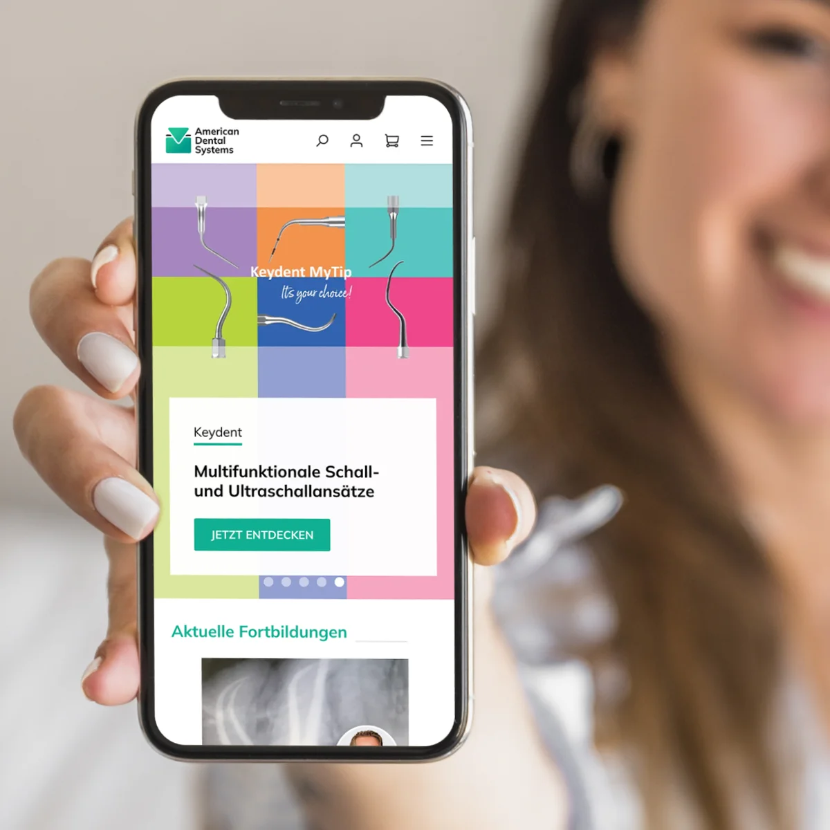 American Dental Systems mobile e-commerce interface on a smartphone held by a woman, showcasing professional dental instruments