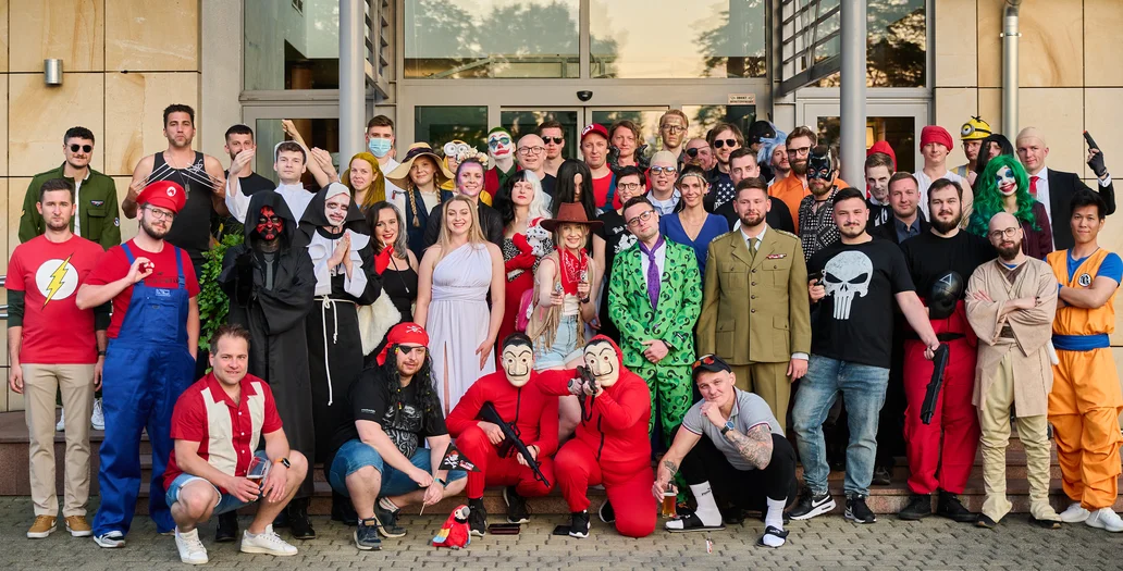 The team in colorful party costumes