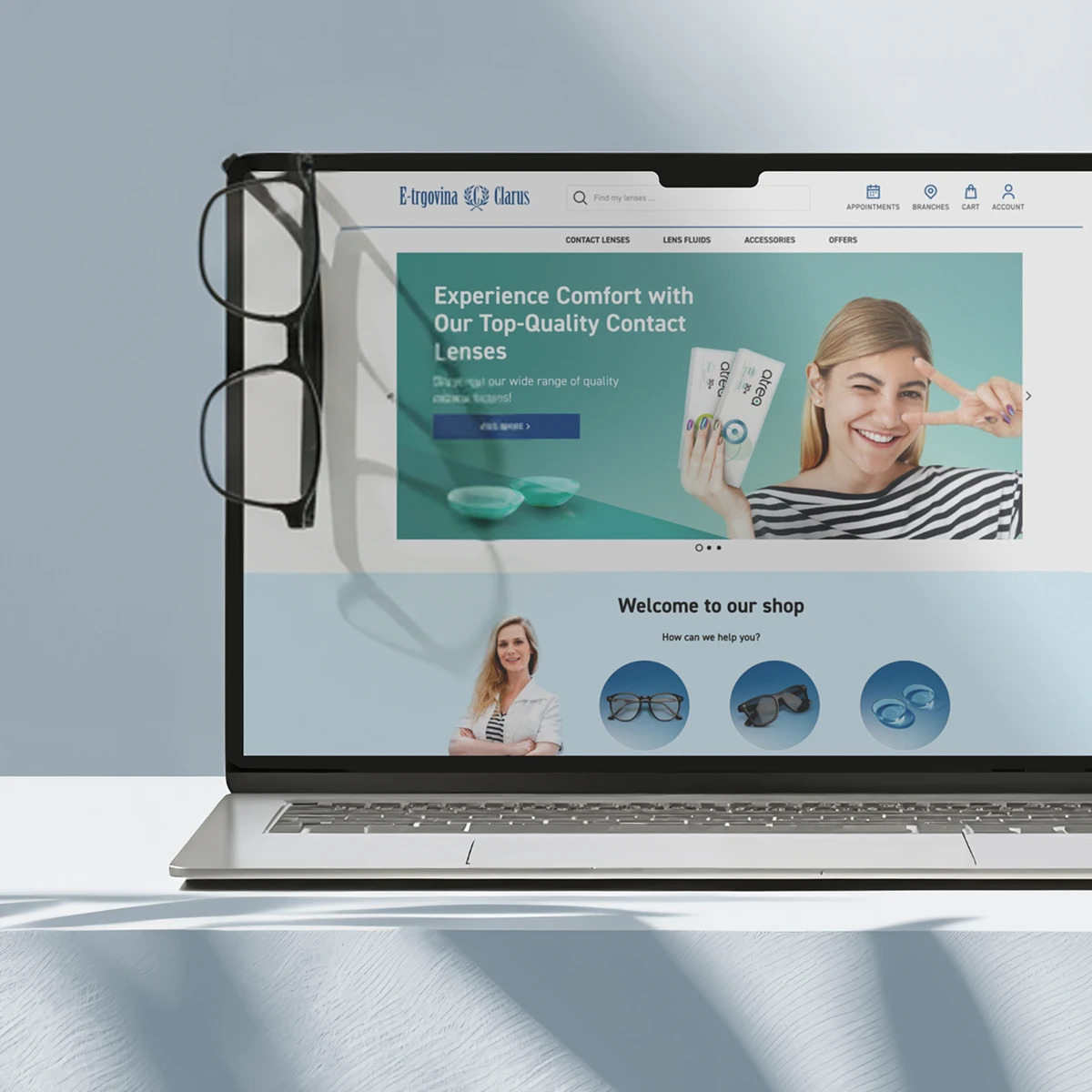 E-trgovina Clarus e-commerce website preview on a laptop showcasing top-quality contact lenses and various eyewear categories like glasses and sunglasses