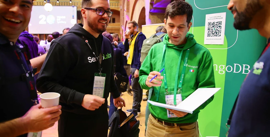 Developers discussing Symfony solutions at conference