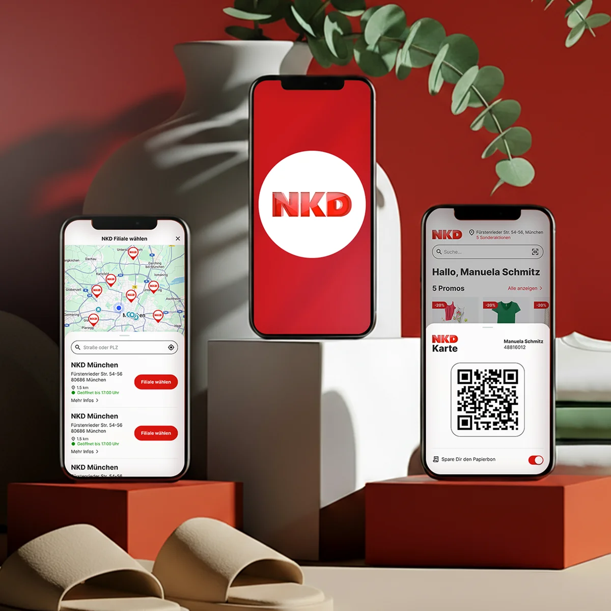 NKD mobile interface preview on three smartphones showcasing a store locator map of Munich, the official NKD logo, and a digital loyalty card "NKD Karte" with a QR code and personalized greeting, set against a background with red pedestals and a green plant