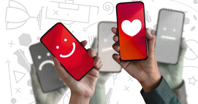 Hands holding smartphones displaying a smiling face and a heart, with blurred faces in the background showing neutral and sad expressions.