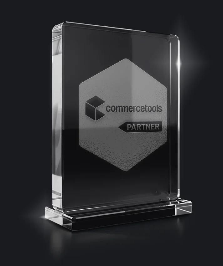 commercetools Partner award trophy as a glass block on a dark background