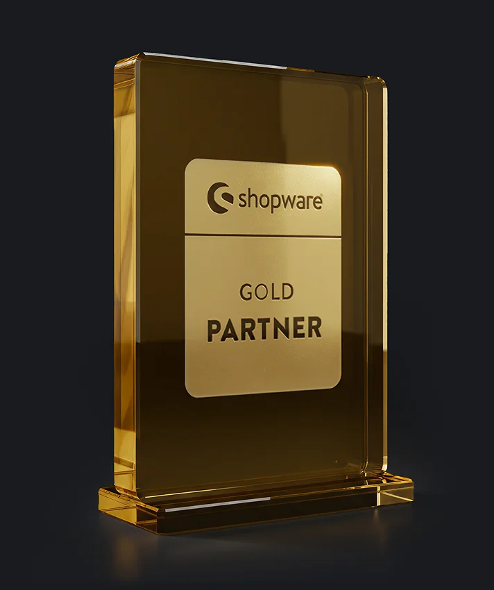 Shopware Gold Partner award trophy as a golden glass block on a dark background