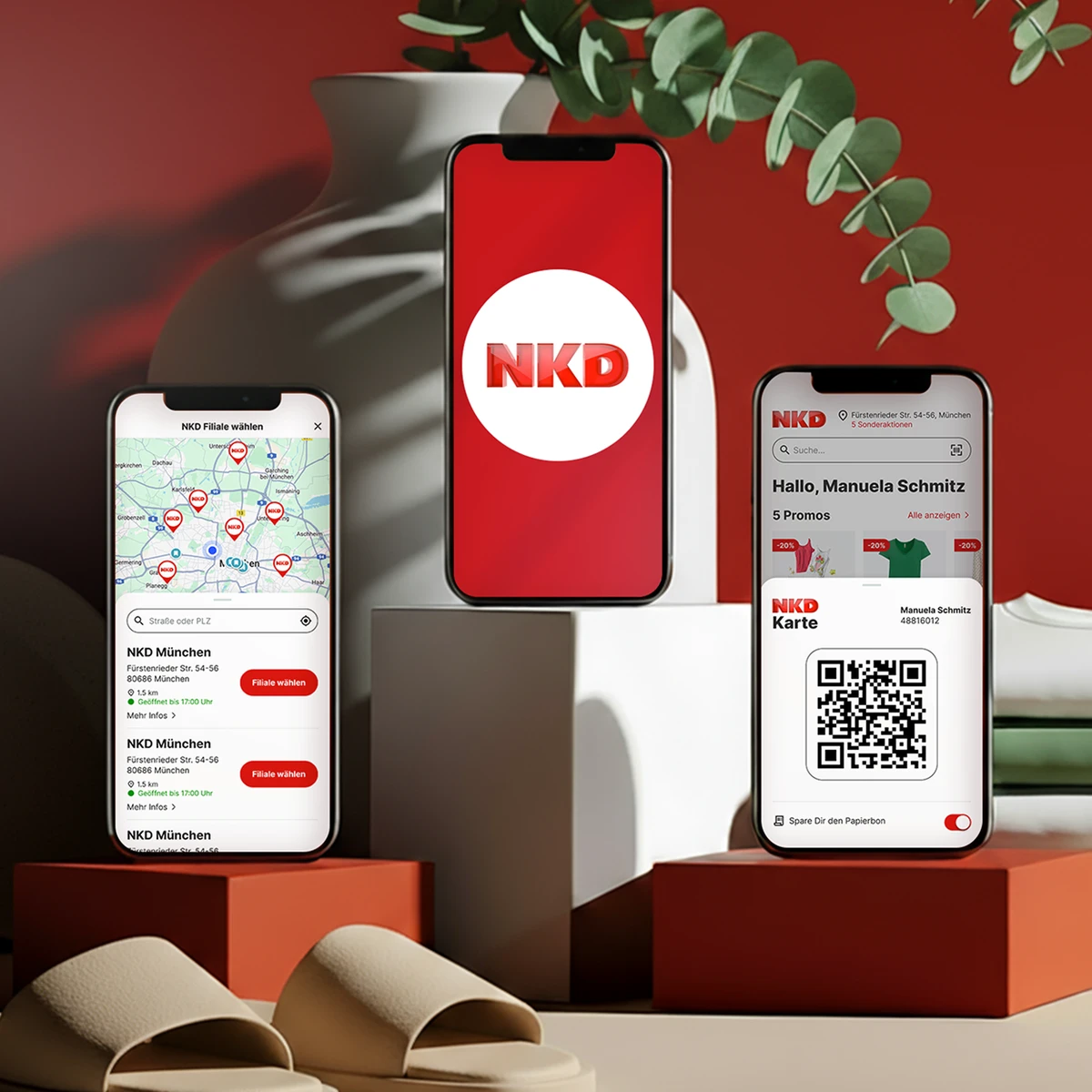 NKD mobile interface preview on three smartphones showcasing a store locator map of Munich, the official NKD logo, and a digital loyalty card "NKD Karte" with a QR code and personalized greeting, set against a background with red pedestals and a green plant