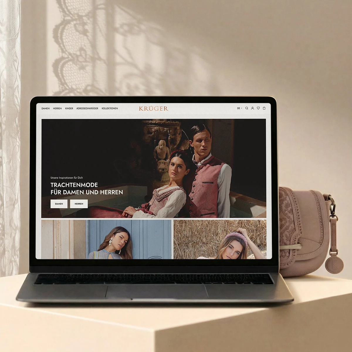 Krüger e-commerce website preview on a laptop showcasing traditional alpine fashion for men and women, set against a soft interior background with a matching pink handbag